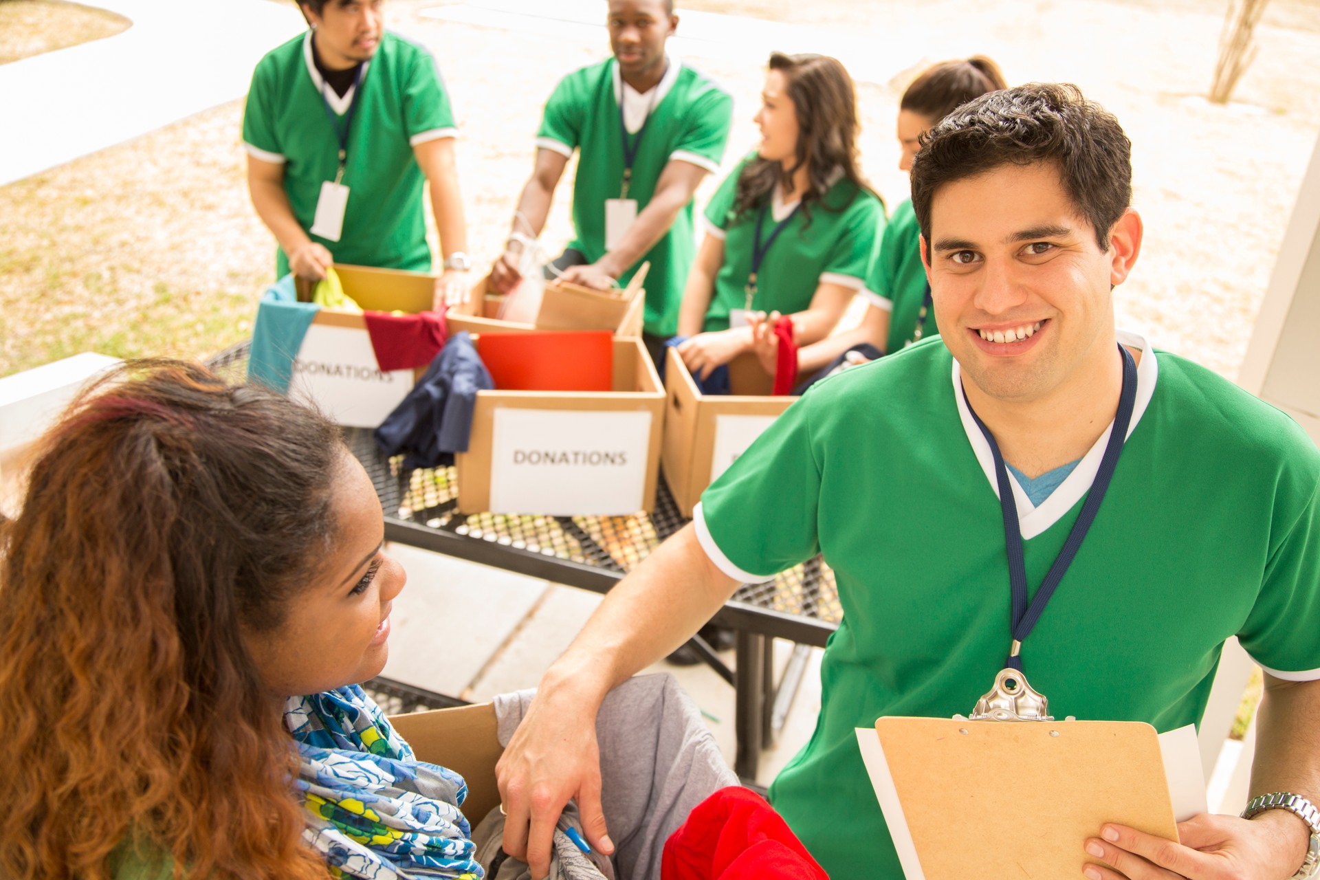 Volunteers: College students collect clothing donations for needy.