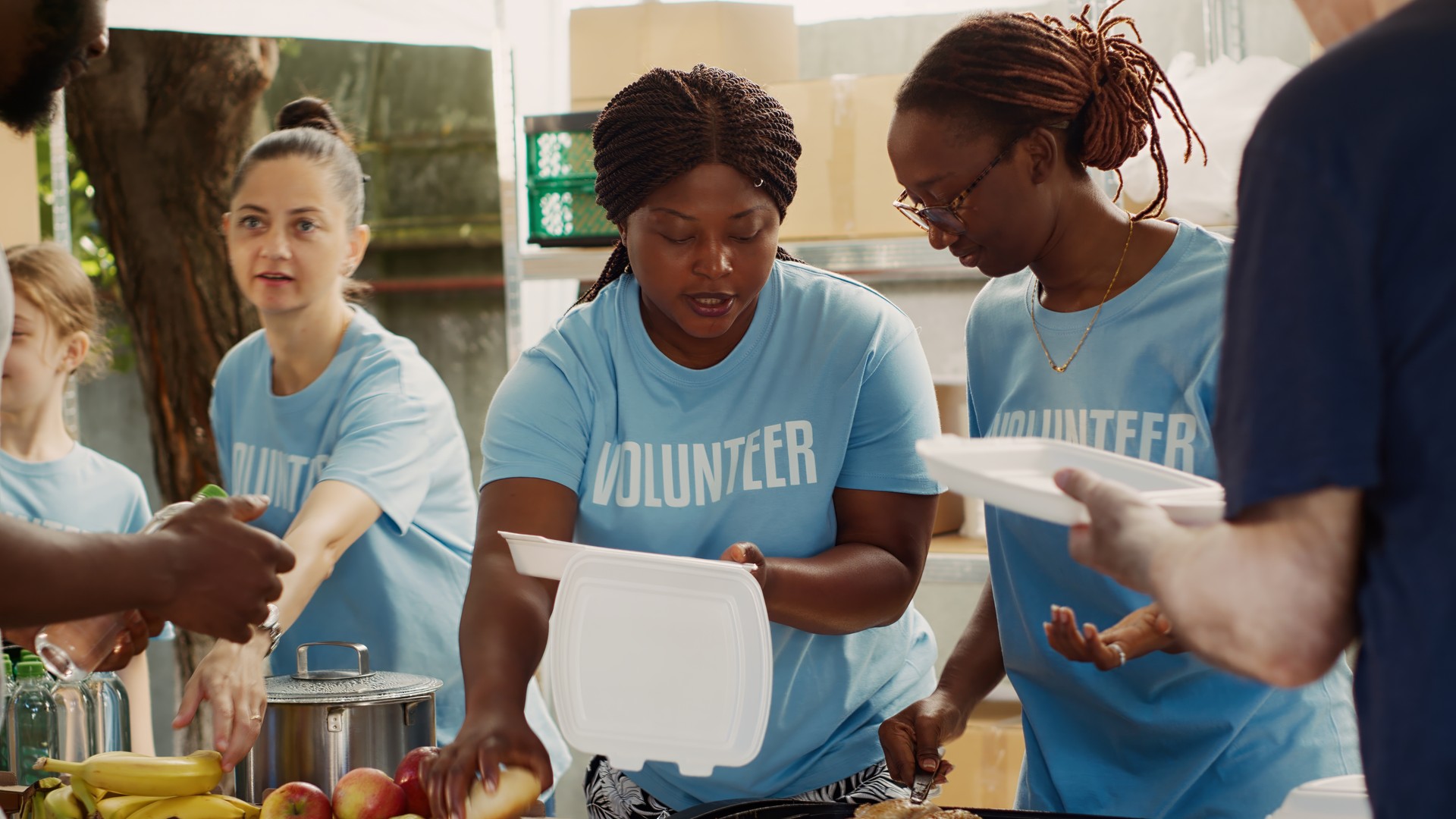 Voluntary Ladies Giving Food To Homeless